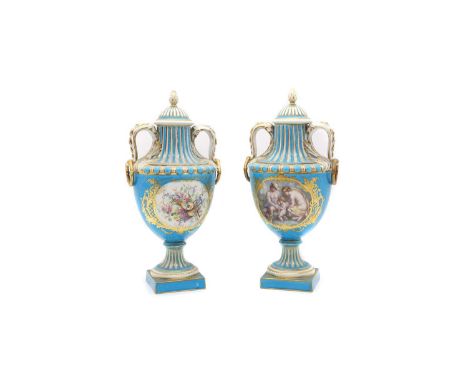 A pair of Sevres style porcelain urns and covers, c.1900, each with a turquoise ground, painted with cartouches with figures,