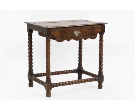 A James II oak side table late 17th century, with one short drawer, with bobbin turned legs, 69cm wide46cm deep66.5cm highCon