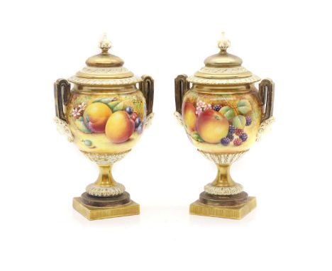A pair of Royal Worcester 'Fruit Study' porcelain vases, 20th century, model 2363, each of twin-handled pedestal urn form, co