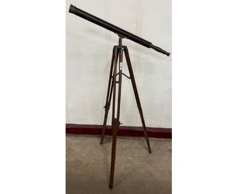 An early 20th century brass telescope on tripod stand