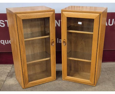 A pair of Ercol Blonde ash wall hanging display cabinets
