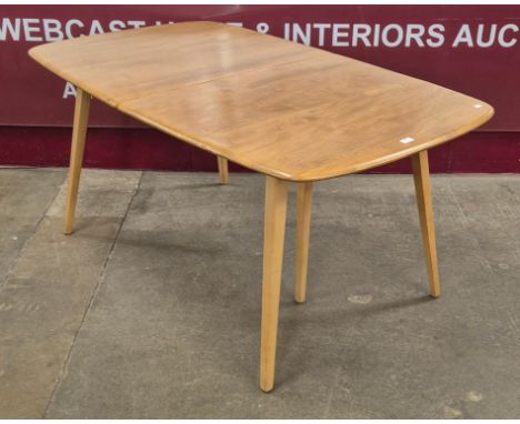 An Ercol Blonde elm and beech Grand Windsor extending dining table