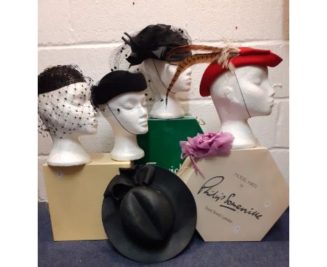 A quantity of 20th Century hats comprising a Philip Somerville black silk hat with net and bow detail, a Bil Horsman red felt