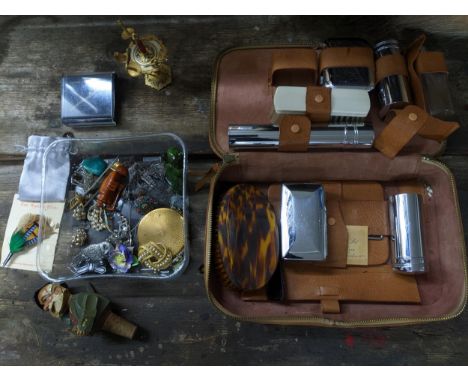 A mixed lot of costume jewellery, a Swiss carved wooden figural bottle opener, wooden netsuke, and a leather cased vanity set