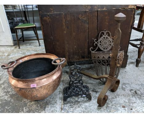 A copper twin ring handled planter, wall hanging flower basket, wrought iron fire dog, and one other item Location: 