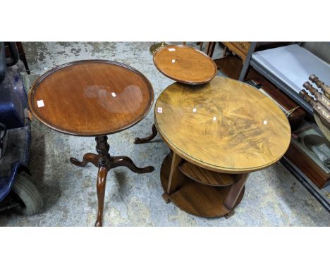 An Art Deco period walnut three tier circular table with quarter cut and glass top, supported on slat columns and stepped fee