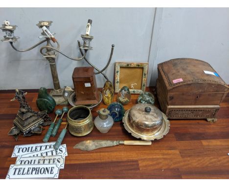 A mixed lot to include a silver plated twin branch candelabra, three glass paperweights, four small enamel signs and other it