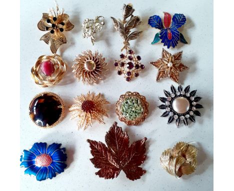 A group of vintage floral inspired gold tone brooches having various coloured cabochons and faux pearls to include Sarah Cove