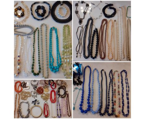 A quantity of vintage costume jewellery, mainly bead necklaces to include a 3-strand Aurora Borealis necklace with sterling s