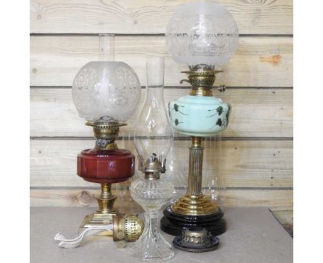 A 19th brass century oil lamp, with an opaline glass reservoir and etched shade, 61cm high, together with two others and vari