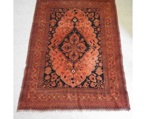 A Turkish carpet, with a large central medallion, on a red ground, 290 x 205cmCondition report: Dirty, with some light worn a