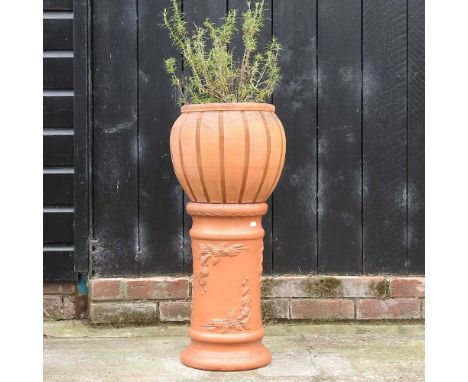 A terracotta planter on column, 73cm high overallCondition report: Weathered but complete. Top and bottom do not appear to ma