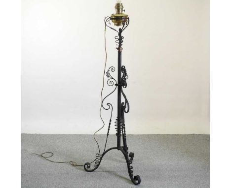 An Arts and Crafts style wrought iron telescopic lamp stand, approx 160cm high