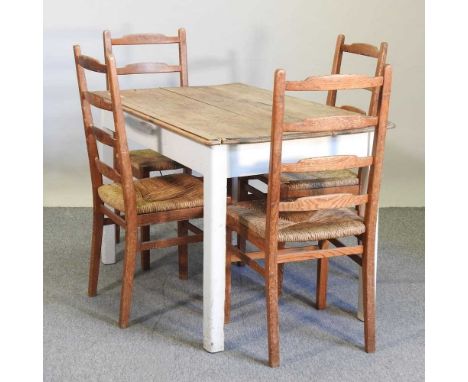 A pine and painted kitchen table, together with four rush seated ladder back chairs122w x 76d x 77h cm