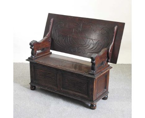 An early 20th century carved oak monk's bench, with a rising seat107w x 46d x 66h cm closed