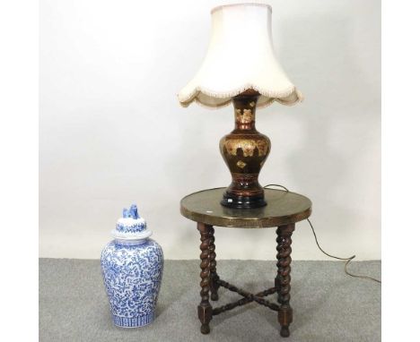 An early 20th century Indian brass top occasional table, together with a modern Chinese blue and white ginger jar and cover a