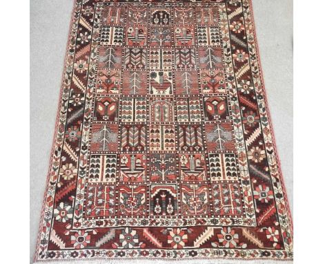 A Turkish woollen carpet, with geometric design, within multiple borders, on a red ground, 285 x 203cmCondition report: Has l