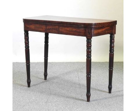 A Regency mahogany fold over card table, on ring turned legs90w x 44d x 74h cm
