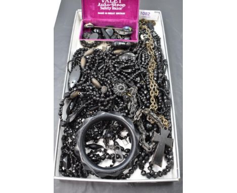 A selection of black morning jewellery including bog oak chain with cross pendant having mother of pearl decoration, bracelet