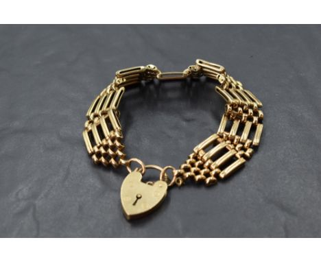 A 9ct gold four bar gate bracelet having padlock clasp,  approx 25g
