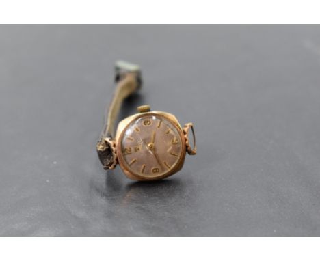 A lady's vintage 9ct gold wrist watch by Tissot having baton and Arabic numeral dial and leather strap (AF)