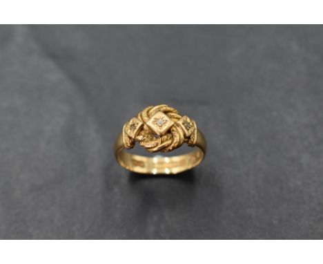 An 18ct gold and diamond chip ring in star burst setting in a knot mount, size O and approx 4.8g. 1 diamond chip missing