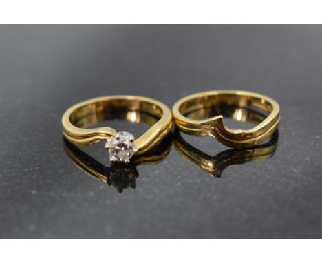 A diamond solitaire ring, approx 0.45ct in a six claw set mount to cross over shoulders on an 18ct gold loop with a matching 