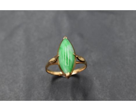 A yellow metal and jadeite ring, the marquise shaped green stone between slender shaped shoulders, unmarked, ring size O, 3.2