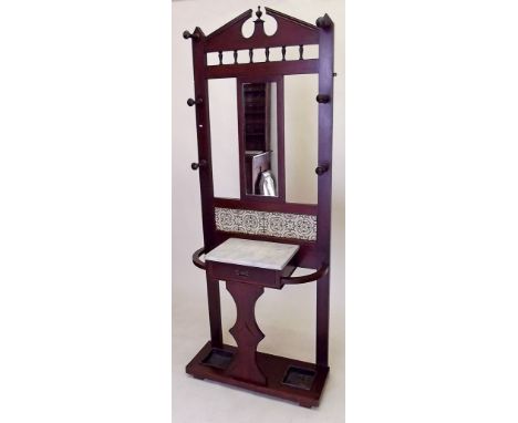 A Victorian mahogany hallstand with mirror and tile back over marble top and stick stands 