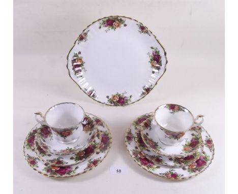 A Royal Albert Country Roses part dinner and tea service comprising: four dinner plates, seven side plates, six tea plates, s