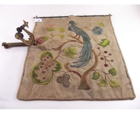 A Victorian embroidered firescreen on extending gilt metal arm with clamp