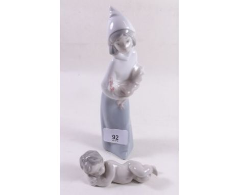 A Lladro figure of a girl with a hen and a Lladro figure of a sleeping baby 