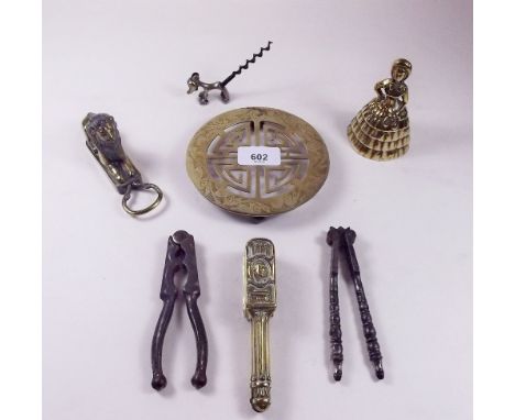 An Art Deco brass dog corkscrew, three pairs of nutcrackers, lion bottle opener etc.