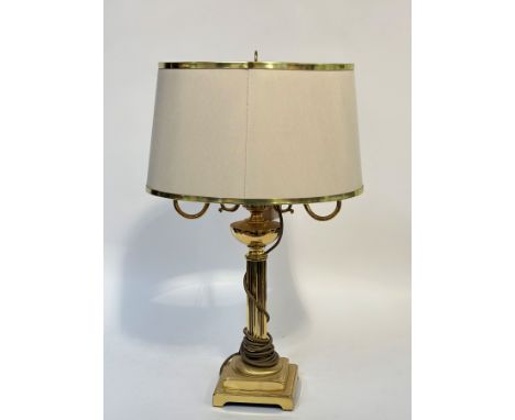 A brass lamp with shade  modeled on a fluted column on a square tapered base. (h- 66cm w-43cm)