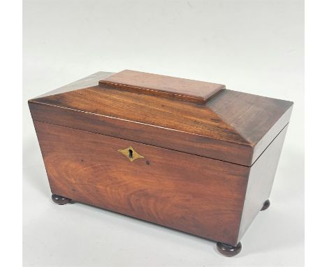 A 19thc mahogany sarcophagus tea caddy, the hinged top enclosing a fitted interior, with open centre section, with 19thc hand