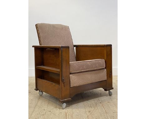 An Art Deco period walnut reclining library chair with ash tray and book trough to each end, moving on castors W67cm
