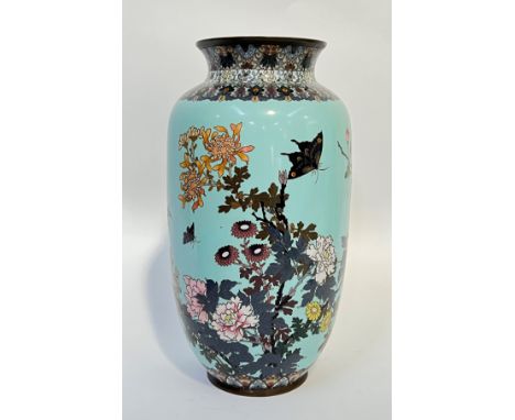 A large Meiji period Japanese cloisonne vase depicting birds and butterflies on a pale blue ground with mixed wire thickness,