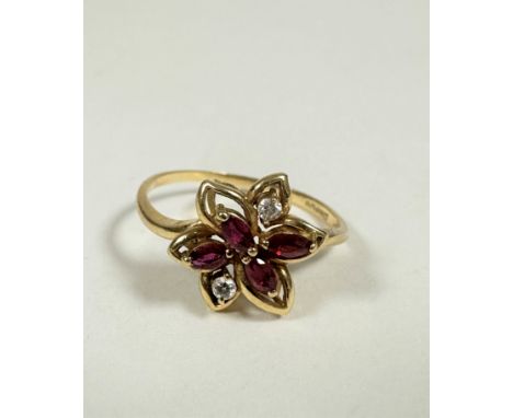 An 18ct gold marquise cut ruby (0.15ct) and two stone diamond floral cluster ring, in open setting, with diamond points (Q) (