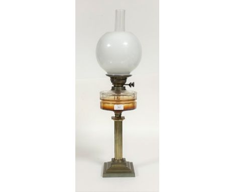 A late 19th/ early 20th century oil lamp, the gilt brass reeded column on a stepped square base supporting original cut glass