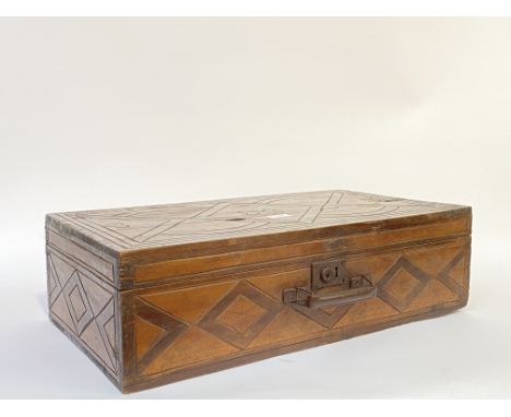 A late 19th century carved and stained pine carpenters tool box, hinged lid opening to a plain interior, H17cm, W60cm, D34cm