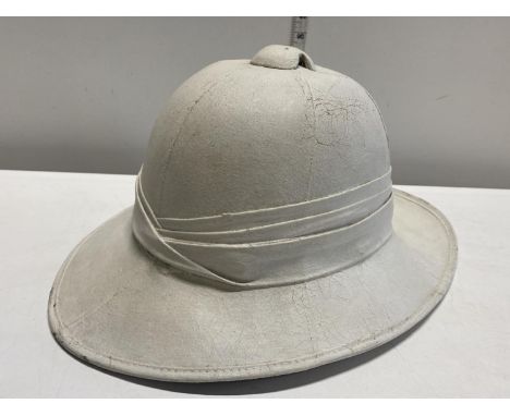 A WW2 Pith helmet by Failsworth Hats Ltd dated 1942 with broad arrow 