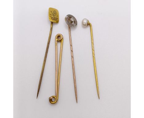 A 9ct gold and diamond stick pin, a bar brooch, and two stick pins (4) 