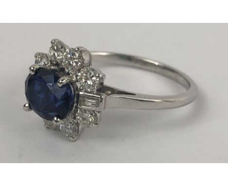 A white metal, sapphire and diamond cluster ring, ring size M 