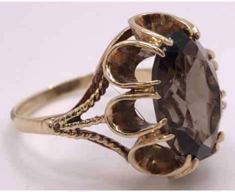 A 9ct gold and brown stone ring, ring size O, and a silver signet ring 
