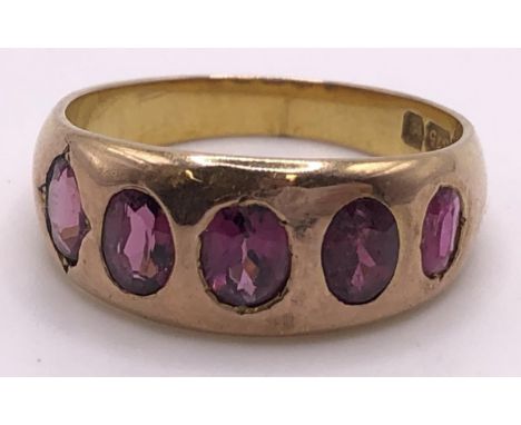 A 9ct gold and pink stone five stone ring, ring size N 