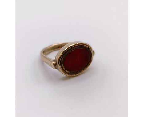 A 9ct gold and carved red stone intaglio ring, decorated a portrait, ring size N approx. 
