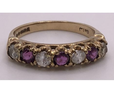 A 9ct gold, garnet and white stone ring, ring size M 