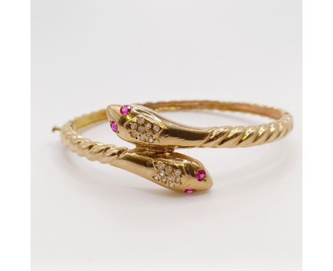 An 18ct gold, ruby and diamond snake bangle, 19.7 g all in 