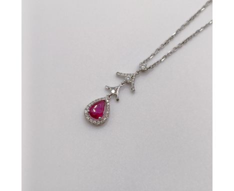 An 18ct white gold, ruby and diamond pendant, on an 18ct gold chain 