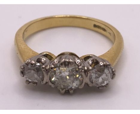 An 18ct gold and three stone diamond ring, ring size L 